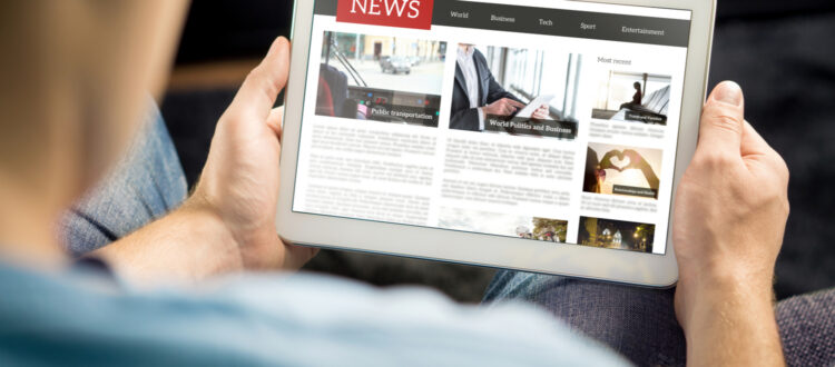 A man reading the news on a tablet.