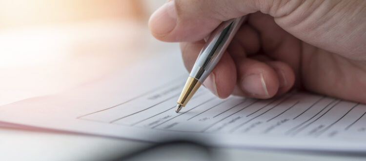 A person filling in paperwork.