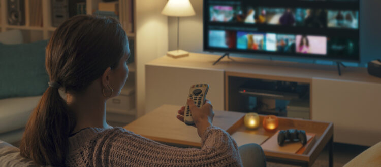 Woman browsing through TV menu.