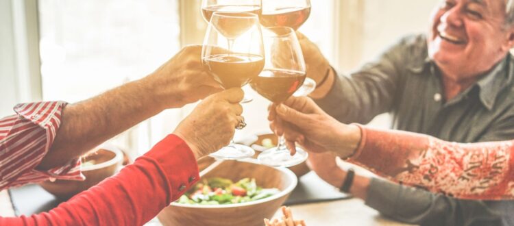 A group of friends cheering with wine.