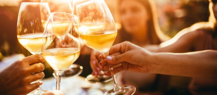 A group of friends clinking wine glasses.