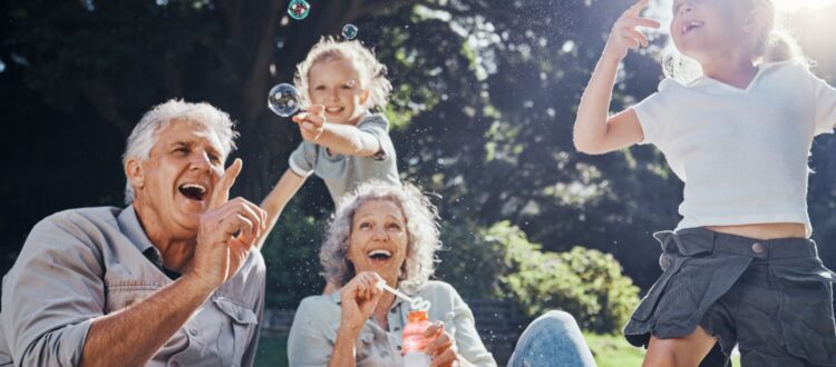 Grandparents blowing bubbles with their grandchildren.