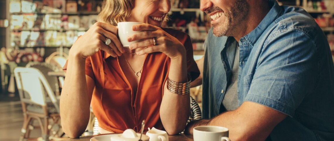 A couple laughing in a café.