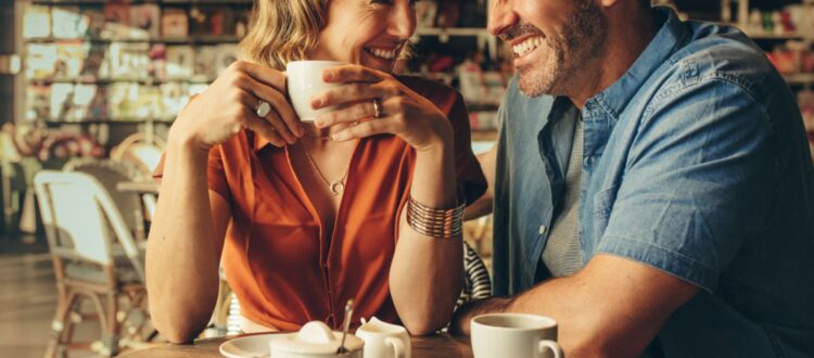 A couple laughing in a café.