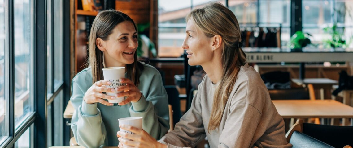 Two women talking in a coffee shop.