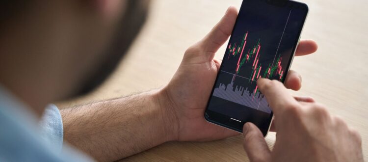 A man looking at investment performance on his phone.