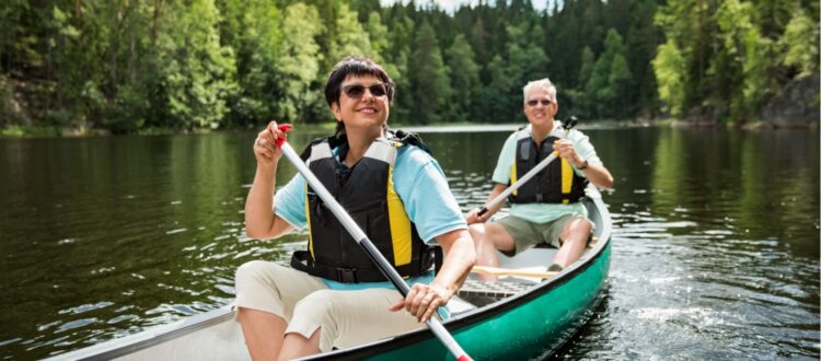 A couple on holiday taking a canoe ride.