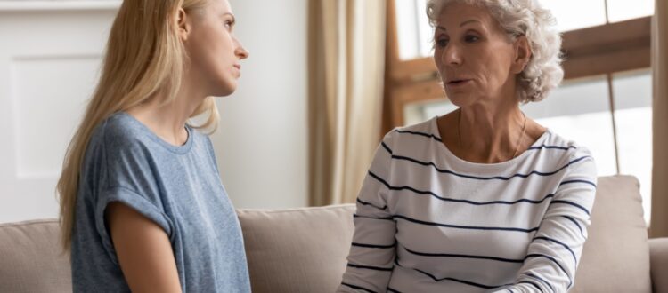 A mother and adult daughter talking.