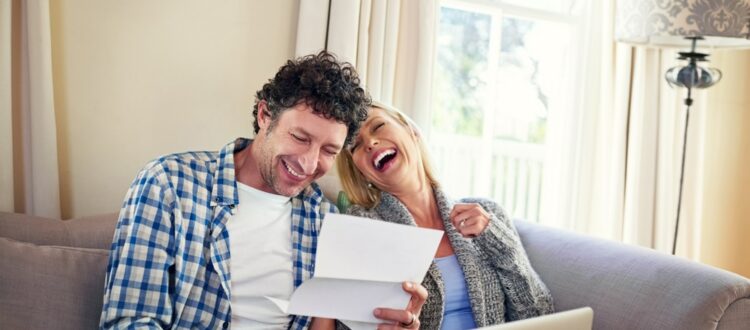 A happy couple reviewing paperwork.