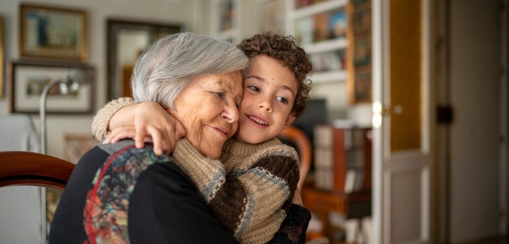 A woman hugging her grandchild.