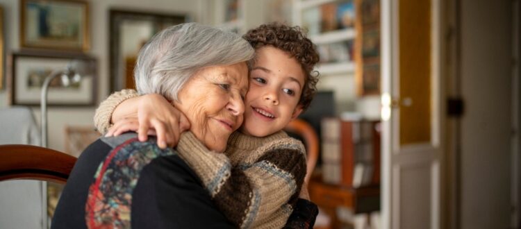 A woman hugging her grandchild.