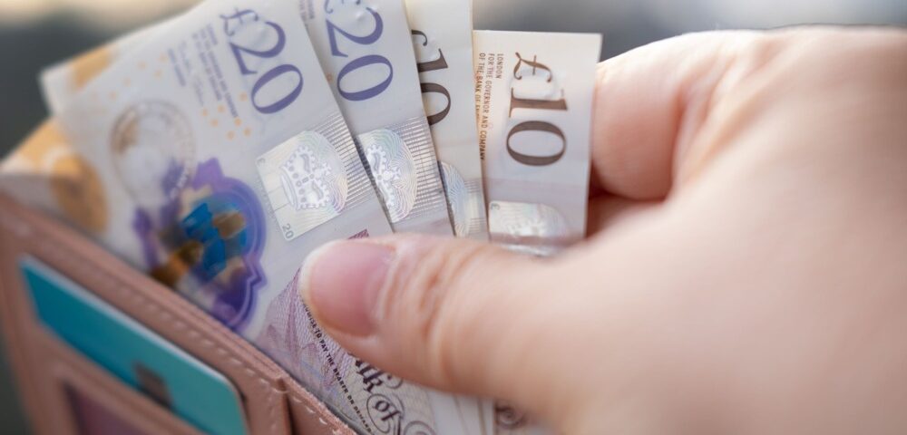 Someone taking money out of a wallet.