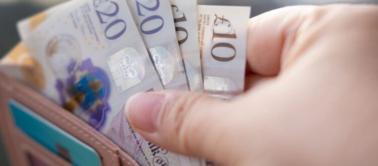 Someone taking money out of a wallet.